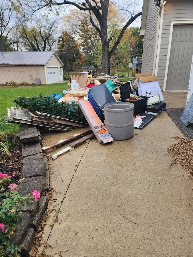 Dumpster being loaded with debris for Estate Cleanout Dumpster Rental in Hollywood Park